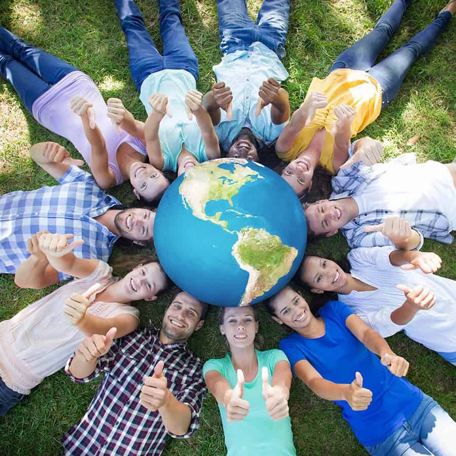 Earth against happy friends in the park lying in circle